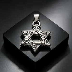 Close-up macro view of a vintage stainless steel hexagram Star of David pendant for men.