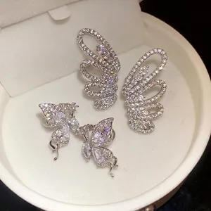 Sparkling cubic zirconia butterfly and wing ear clips in elegant white jewelry box
