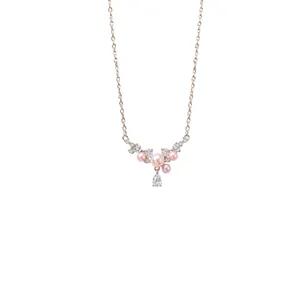 Elegant gold chain necklace with pink pearls and a sparkling teardrop zircon pendant.