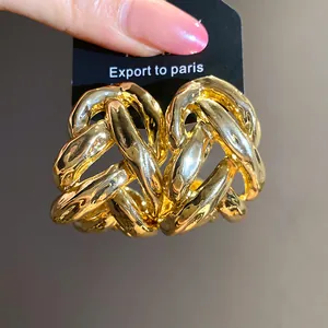 Detailed close-up of chunky gold-toned chain-link C-shaped hoop earrings for women