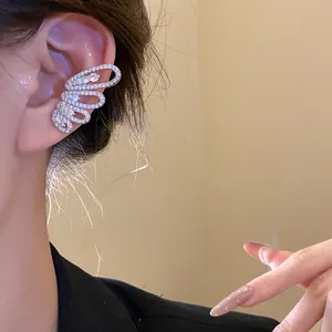Close-up detail of a sparkling zircon butterfly wing ear cuff on ear without piercing