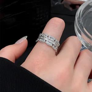 Elegant close-up shot of a luxury zircon scalloped open ring worn on a person's finger