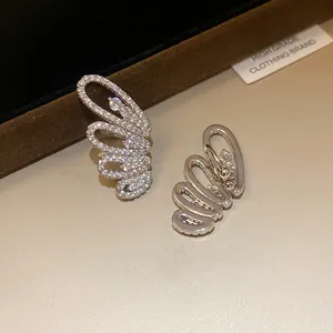 Close-up detail of silver-toned zircon butterfly wing ear cuffs for non-pierced ears