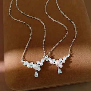 Close-up of white and pink pearl necklaces with water-drop cubic zirconia details