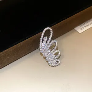 Detailed shot of a silver butterfly wing ear cuff encrusted with sparkling cubic zirconia