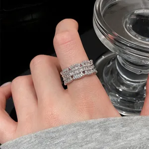 Detailed macro view of an intricate silver lace ring with sparkling cubic zirconia
