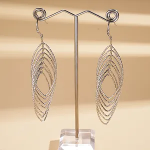 Detail of silver-toned multi-layer oval drop earrings with elegant textured finish
