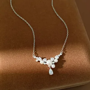 Detailed macro shot of an elegant pearl and zircon necklace featuring water drop pendant.