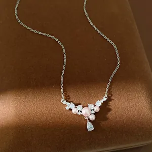 Close-up of elegant necklace featuring pink pearls and sparkling waterdrop zircon