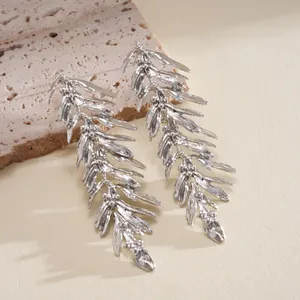 Close-up view of vintage silver leaf-shaped drop earrings featuring a unique molten metal texture