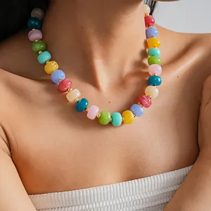 Detailed view of vibrant colorful acrylic beaded necklace worn by model on neck