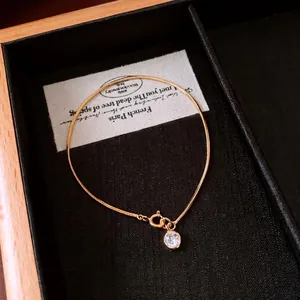 Elegant 18K gold plated snake chain bracelet featuring a sparkling round zircon charm
