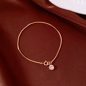 Detail shot of 18K gold plated snake chain bracelet with sparkling cubic zirconia pendant