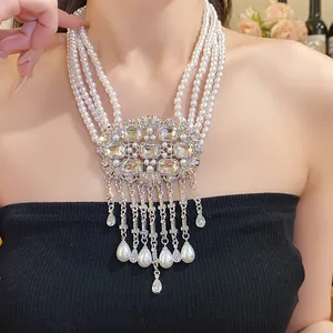 Close-up of multi-strand pearl necklace with rhinestone center and teardrop fringe