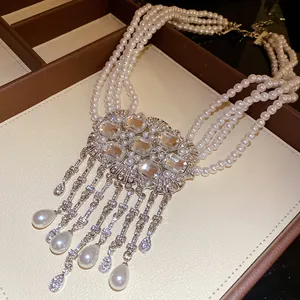 Detailed close-up view of a multi-layer pearl necklace with elegant crystal tassels