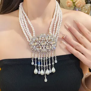 Close-up of multi-layer pearl necklace with rhinestone center and tassel detail