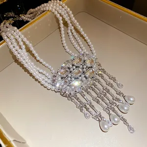 Close-up of elegant multi-layer pearl necklace with sparkling crystal centerpiece and tassels