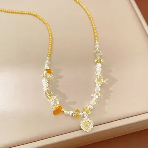 Handmade yellow beaded necklace with glass stones and a zircon flower pendant charm