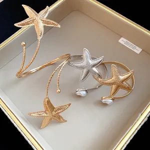 Elegant starfish arm cuff bracelets in gold and silver finish with pearl accents