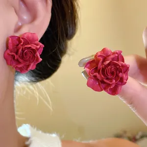 Detailed close-up view of retro elegant red rose flower stud earrings for women.