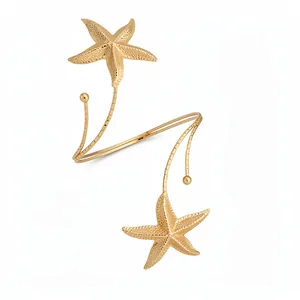 Elegant golden metallic upper arm cuff bracelet featuring a dual starfish design