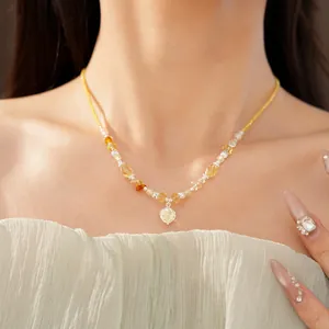 Detailed view of elegant floral pendant necklace with yellow stone beads and zircon