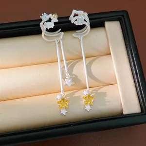 Elegant zircon star tassel ear clips for non-pierced ears presented in jewelry box.