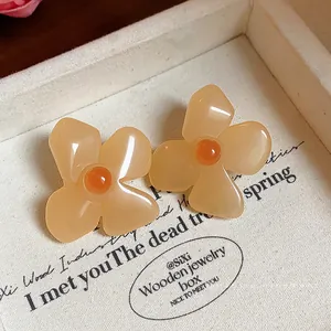 Elegant retro resin flower stud earrings featuring peach petals and orange bead centers