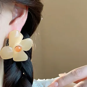 Elegant resin flower stud earrings with vintage cream petals and orange center