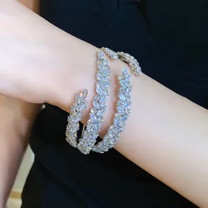 Detailed view of a sparkling zircon triple-layer leaf crossover open cuff bracelet on wrist