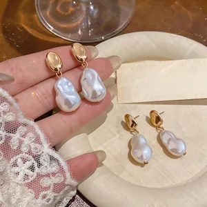 French vintage gold-toned drop earrings featuring irregular baroque-style white pearls
