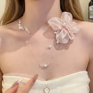 Elegant champagne chiffon flower necklace with dainty pearl bead strands on model