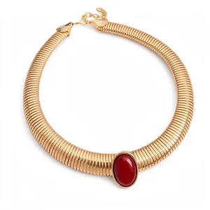 Vintage gold-toned metal choker necklace featuring a prominent oval red resin center stone.