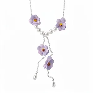 Elegant silver chain necklace with light purple chiffon flowers and white faux pearl accents.