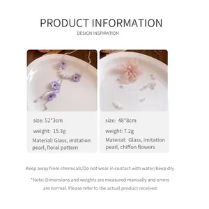 Detail of handmade pearl beaded necklaces with purple and pink chiffon floral accents.