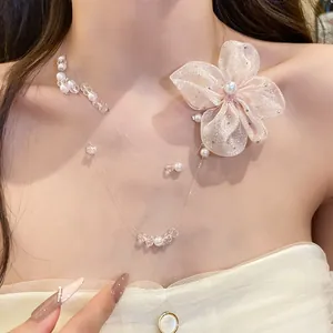 Detailed view of sweet style pearl beaded necklace featuring a large pink shimmering chiffon flower