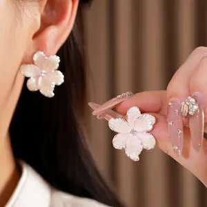 Elegant pink floral stud earrings with silver needles and sparkling zircon center