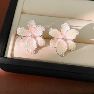 Sweet pink enamel flower stud earrings with zircon detail presented in a premium jewelry box
