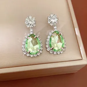 Vintage luxury teardrop earrings with green crystal and rhinestone halo