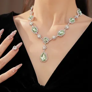 Elegant luxury court style necklace featuring green teardrop gemstones and sparkling crystals
