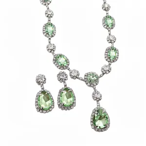 Elegant palace style jewelry set featuring light green teardrop and oval crystal pendants