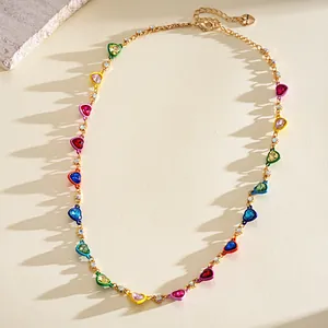 Detailed view of vibrant enamel heart necklace with sparkling rhinestones on gold chain