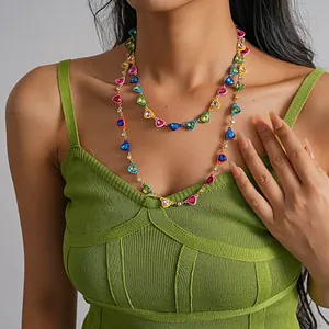 Detailed view of colorful dopamine heart necklace with drip oil and rhinestones on model