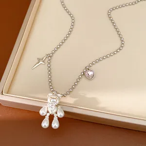 Detailed macro view of a cute pearl bear necklace with zircon star pendant