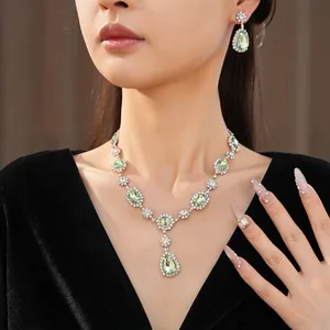Close-up of elegant palace style jewelry set featuring green teardrop gems and crystals