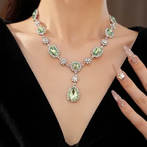 Close-up of luxury palace style necklace with green waterdrop and oval crystals