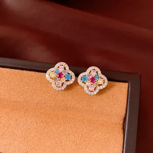 Macro view of vintage style 14k gold plated flower stud earrings with colorful zircons