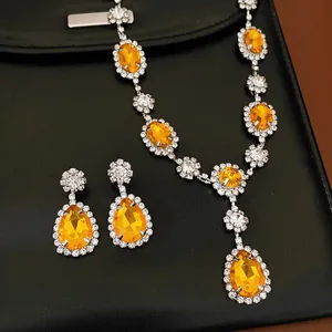 Exquisite orange gemstone jewelry set with teardrop earrings and oval stone necklace
