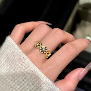 14k gold plated starburst ring with sparkling zircons shown on a female model's finger