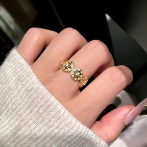 14k gold plated ring featuring circular motifs with sparkling zircon star design